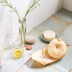 Natural sisal palm body brush with compact round profile and hanging loop